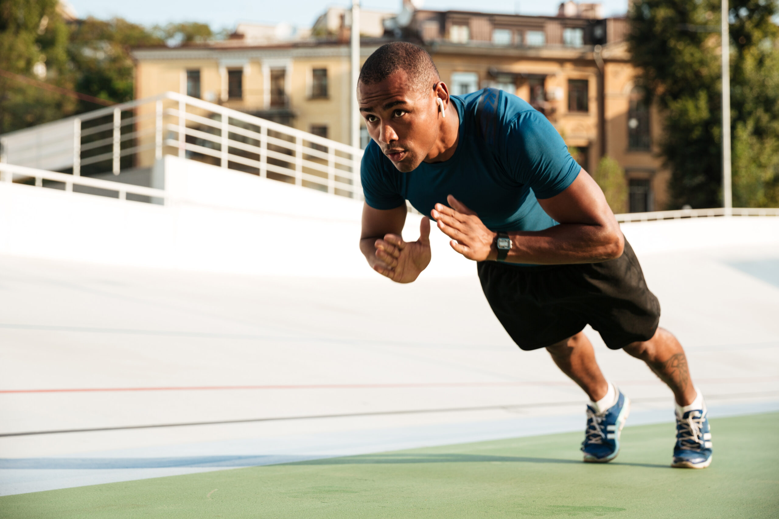 portrait of a fit afro american sportsman doing push ups